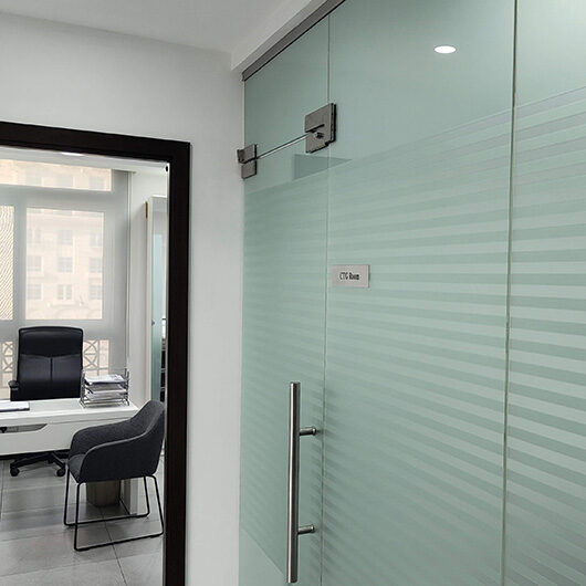 Frosted glass OTC room door and nearby consultation office at Femiclinic Dubai Healthcare City